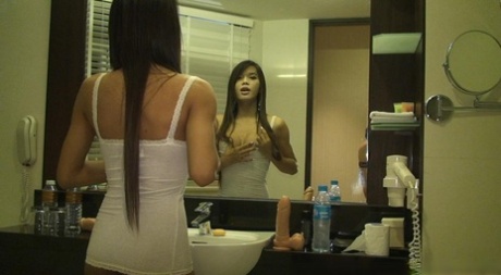 Bootylicious ladyboy Pam sliding a dildo in her tight anus before going out