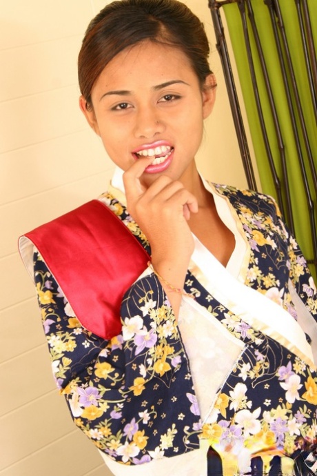 Teenage Asian ladyboy in colorful blouse teases small pecker solo