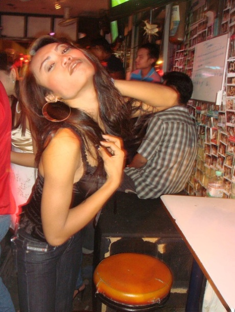Tourist during walk on night streets takes photos of various ladyboys