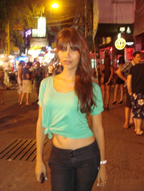 Tourist during walk on night streets takes photos of various ladyboys