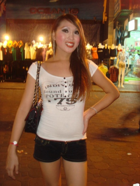 Tourist during walk on night streets takes photos of various ladyboys