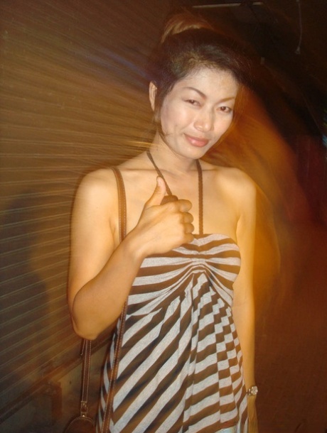 Tourist during walk on night streets takes photos of various ladyboys