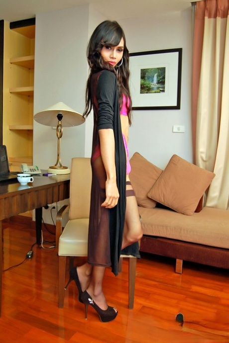 Long-haired ladyboy Mint smoking and wanking her huge dick on the furniture