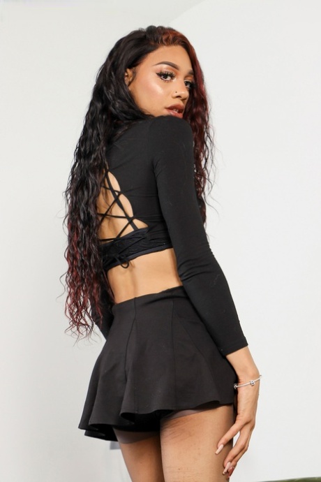 Skinny ebony shemale Brooklynn removes her clothes and poses naked