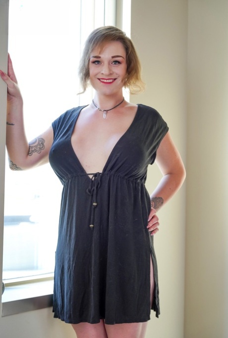 Chubby shemale Belle De Jour shows off her big tits & her hard dick on her bed