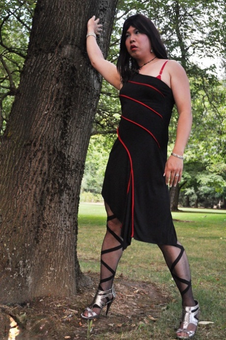 Naughty shemale shows her tight ass in panties & stockings outdoors