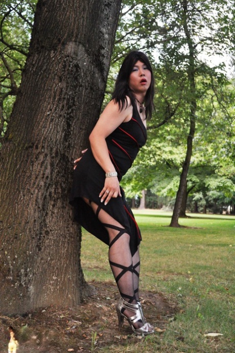 Naughty shemale shows her tight ass in panties & stockings outdoors