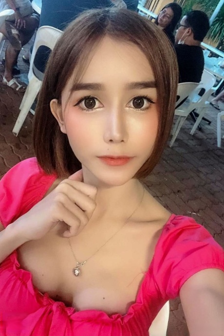 Attractive Asian shemale Bella shows her cleavage in her solo compilation
