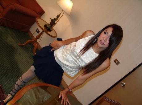 Asian shemale Mey jacks off her dick after stripping to white stockings